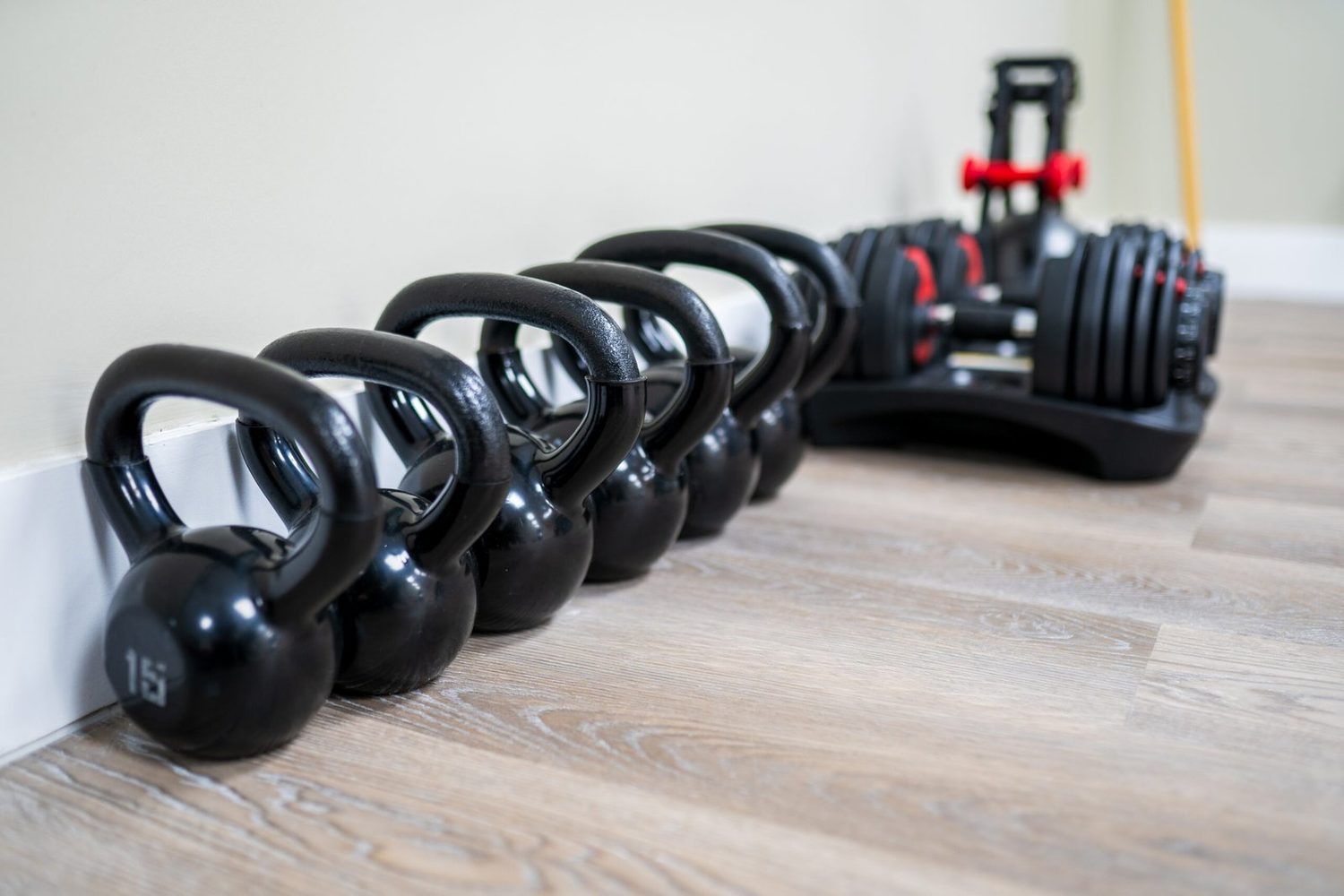 Kettlebells racked along the wall of the BodyForge training floor.