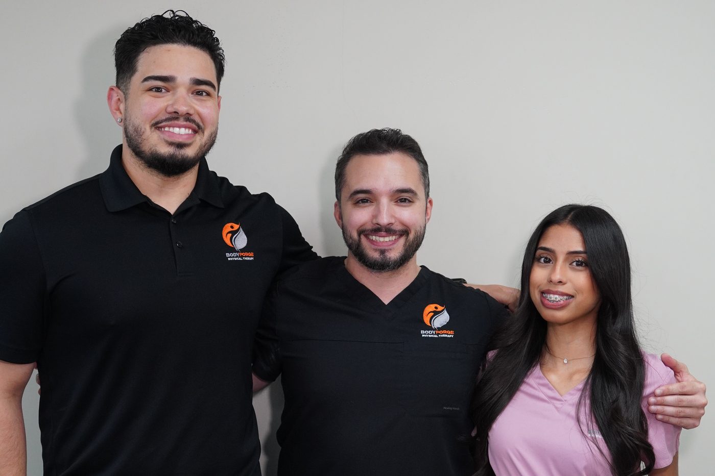 The BodyForge clinical team, three clinicians standing together at the clinic on West Flagler Street.